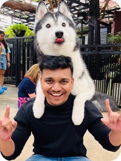 Smiling with a husky draped over my shoulders