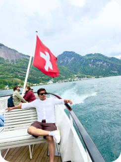 Relaxing on a boat under a Swiss flag on a mountain lake